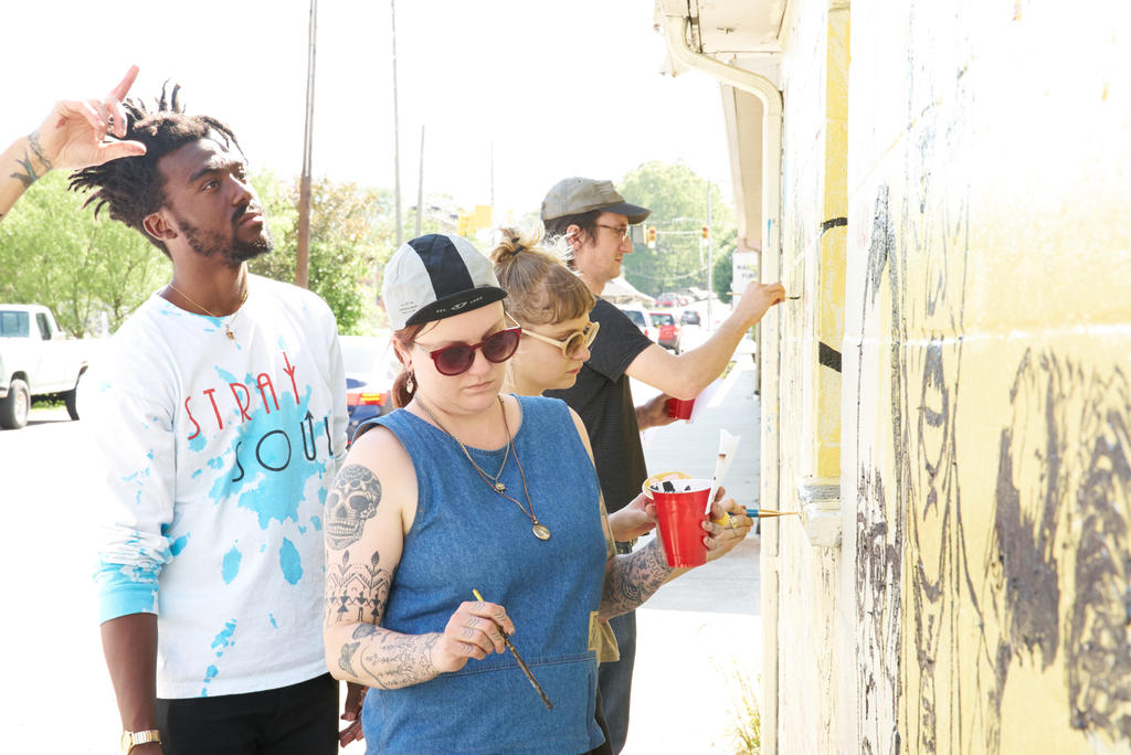 Students working during Tim Kerr&#039;s Mural Painting class, which created a mural honoring BMC  in Downtown Black Mountain. Photo by Suzi Sadler